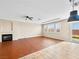 Spacious living room features a fireplace, recessed lights, ceiling fan, herringbone flooring and lots of natural light at 6982 Mirkwood Ave, Las Vegas, NV 89178