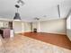 Open living space with fireplace, herringbone flooring, recessed lighting, ceiling fan, and kitchen with granite countertops at 6982 Mirkwood Ave, Las Vegas, NV 89178