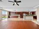 Open-concept living space featuring tile floors and a well-equipped kitchen with modern stainless steel appliances at 6982 Mirkwood Ave, Las Vegas, NV 89178