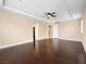 Open main bedroom featuring wood floors, tray ceilings, access to the hallway and a full closet at 6982 Mirkwood Ave, Las Vegas, NV 89178
