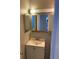 Well-lit bathroom features a large mirror and a white vanity with cabinet storage at 709 Scholl Dr, Las Vegas, NV 89107