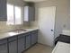 Functional kitchen with gray cabinetry, a stainless steel sink, and ample counter space at 709 Scholl Dr, Las Vegas, NV 89107