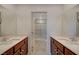 Bathroom featuring a double sink vanity, tile floor, and shower at 757 Omaggio Pl, Henderson, NV 89011