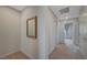 Hallway area with neutral carpet, a decorative mirror, and doors at 757 Omaggio Pl, Henderson, NV 89011