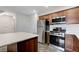 Efficient kitchen with stainless steel appliances, wooden cabinets, and a functional layout for easy cooking at 757 Omaggio Pl, Henderson, NV 89011
