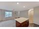 Spacious open-plan kitchen and living area with island, offering functionality and a modern design at 757 Omaggio Pl, Henderson, NV 89011