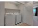 Convenient laundry room with washer, dryer, and shelving at 757 Omaggio Pl, Henderson, NV 89011
