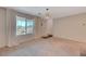 Inviting living room with large window and neutral carpet, offering a comfortable and versatile living space at 757 Omaggio Pl, Henderson, NV 89011