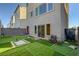 View of the backyard with turf and easy access through sliding door at 7953 Mountain Lilac St, Las Vegas, NV 89113