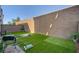 Private backyard with turf, grill, and paved patio area at 7953 Mountain Lilac St, Las Vegas, NV 89113