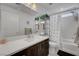 Bright bathroom featuring dark cabinets, white counters, and a tub/shower combo at 7953 Mountain Lilac St, Las Vegas, NV 89113