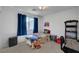 Bedroom featuring blue drapes, twin bed, and desk at 7953 Mountain Lilac St, Las Vegas, NV 89113