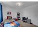 Bedroom featuring blue drapes, twin bed, and desk with rolling chair at 7953 Mountain Lilac St, Las Vegas, NV 89113