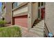Modern three-story home with a two-car garage, desert landscaping, and a decorative front door at 7953 Mountain Lilac St, Las Vegas, NV 89113