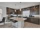 Beautiful kitchen featuring granite countertops, stainless appliances, stylish lighting, and breakfast bar seating at 7953 Mountain Lilac St, Las Vegas, NV 89113