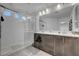 Bright main bathroom with dual sink vanity, frameless shower, and modern fixtures at 7953 Mountain Lilac St, Las Vegas, NV 89113