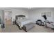 Spacious main bedroom featuring neutral colors, carpeted floors and a tufted ottoman at 7953 Mountain Lilac St, Las Vegas, NV 89113