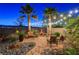 Relaxing backyard seating area with string lights, desert landscaping and rock features at 8113 Bay Colony St, Las Vegas, NV 89131