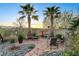 Relaxing backyard with a sitting area, desert landscape, and mountain views in the distance at 8113 Bay Colony St, Las Vegas, NV 89131