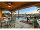 Wonderful backyard with a covered patio, swimming pool, and desert landscape views at 8113 Bay Colony St, Las Vegas, NV 89131