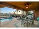 Inviting backyard featuring a covered patio, refreshing pool, and an outdoor dining area at 8113 Bay Colony St, Las Vegas, NV 89131