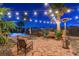 Relaxing backyard retreat featuring a stone patio, lush tropical landscaping, and a cozy seating area at 8113 Bay Colony St, Las Vegas, NV 89131
