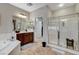 Bright bathroom boasts double vanity, soaking tub, and separate glass-enclosed shower with bench at 8113 Bay Colony St, Las Vegas, NV 89131