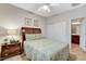 Cozy bedroom featuring a comfortable bed, a ceiling fan and an adjacent bathroom at 8113 Bay Colony St, Las Vegas, NV 89131