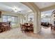 Dining room with tiled floor, rustic wet bar, and a clear view into the living room and kitchen at 8113 Bay Colony St, Las Vegas, NV 89131
