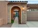 Inviting stone archway leads to a vibrant blue front door with decorative wreath and exterior lighting at 8113 Bay Colony St, Las Vegas, NV 89131