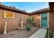 Cozy front porch features a decorative fountain, drought-resistant landscaping, and a teal door at 8113 Bay Colony St, Las Vegas, NV 89131