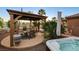 Outdoor gazebo with comfortable seating, spa, and pool, perfect for relaxation and enjoying the serene surroundings at 8113 Bay Colony St, Las Vegas, NV 89131