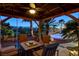 Backyard gazebo with comfortable seating and elegant lighting, perfect for entertaining overlooking the pool at 8113 Bay Colony St, Las Vegas, NV 89131