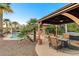 Outdoor gazebo with comfortable seating, spa, and pool, perfect for relaxation and enjoying the serene surroundings at 8113 Bay Colony St, Las Vegas, NV 89131