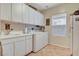 Efficient laundry room equipped with modern washer, dryer, sink, and ample storage cabinets at 8113 Bay Colony St, Las Vegas, NV 89131