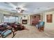 Inviting living room with a fireplace, ceiling fan, and comfortable seating area at 8113 Bay Colony St, Las Vegas, NV 89131