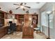 Lovely home office with rich wood built-ins, desk, chair, and natural light at 8113 Bay Colony St, Las Vegas, NV 89131