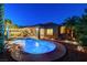 Picturesque backyard pool with lush landscaping and a covered patio for outdoor relaxation at 8113 Bay Colony St, Las Vegas, NV 89131
