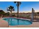 Beautiful in-ground pool featuring water fountain features and lush landscaping in a private backyard oasis at 8113 Bay Colony St, Las Vegas, NV 89131