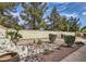Serene backyard garden with lush greenery, decorative rocks, and a stone water feature at 8698 Waterford Bend St, Las Vegas, NV 89123