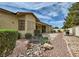 Spacious backyard with a patio area, stone accents, and mature landscaping at 8698 Waterford Bend St, Las Vegas, NV 89123