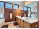 Well-lit bathroom featuring a double sink vanity with a white countertop and honey-colored wood cabinets at 8698 Waterford Bend St, Las Vegas, NV 89123