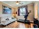Bright bedroom featuring a sofa, treadmill, ceiling fan, and hardwood floors at 8698 Waterford Bend St, Las Vegas, NV 89123