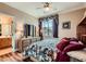 Bedroom features a large bed, dresser with lamps, and a window with curtains at 8698 Waterford Bend St, Las Vegas, NV 89123