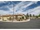 A charming single story home is shown with desert landscaping and a circular driveway at 8698 Waterford Bend St, Las Vegas, NV 89123