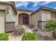 Inviting front entrance features a secured gate, desert landscaping, and a well-maintained walkway to the front door at 8698 Waterford Bend St, Las Vegas, NV 89123