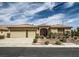 Charming single-story home with a two-car garage, desert landscaping, and an inviting entryway gate at 8698 Waterford Bend St, Las Vegas, NV 89123