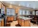 Open concept kitchen features stainless appliances, a granite island, and connects to a dining area at 8698 Waterford Bend St, Las Vegas, NV 89123