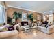 Elegant living room showcasing stylish furnishings, decorative palms, neutral tones, and natural light at 8698 Waterford Bend St, Las Vegas, NV 89123