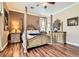 Inviting main bedroom with hardwood floors, a four-poster bed, and designer furnishings at 8698 Waterford Bend St, Las Vegas, NV 89123